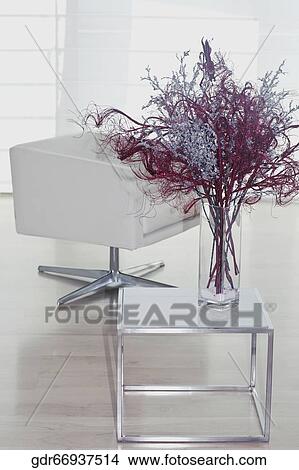 Flower vase with an armchair in a living room View Large Photo Image Picture - Flower vase with an armchair in a living room. Fotosearch