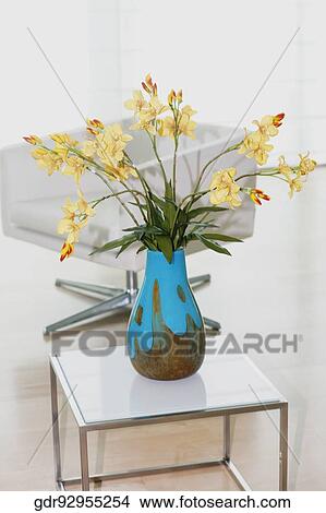 Flower vase with an armchair in a living room View Large Photo Image Picture - Flower vase with an armchair in a living room. Fotosearch
