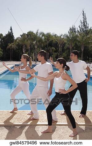 Four friends exercising at the poolside View Large Photo Image Stock Photograph - Four friends exercising at the poolside. Fotosearch