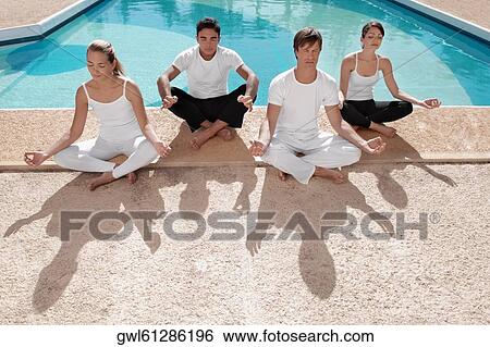 Four friends practicing yoga at the poolside View Large Photo Image Stock Photograph - Four friends practicing yoga at the poolside. Fotosearch