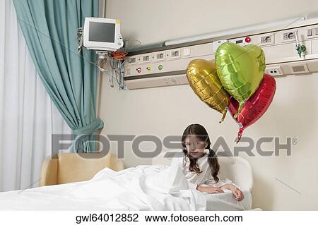 Girl lying in a hospital bed View Large Photo Image Stock Image - Girl lying in a hospital bed. Fotosearch