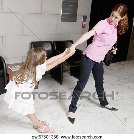 Girl pulling her mother's hand in a hospital View Large Photo Image Stock Photo - Girl pulling her mother's hand in a hospital. Fotosearch