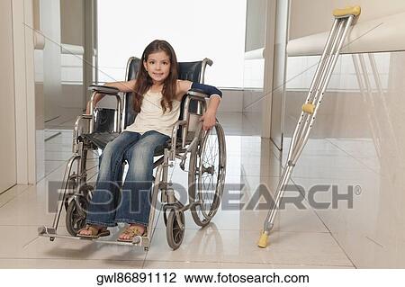 Girl sitting in a wheelchair View Large Photo Image Stock Image - Girl sitting in a wheelchair. Fotosearch