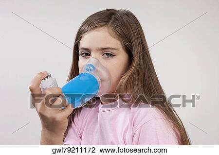 Girl using an asthma inhaler attached with a spacer View Large Photo Image Stock Image - Girl using an asthma inhaler attached with a spacer. Fotosearch