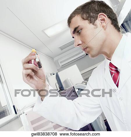 Lab technician testing a blood sample in a test tube View Large Photo Image Stock Photo - Lab technician testing a blood sample in a test tube. Fotosearch
