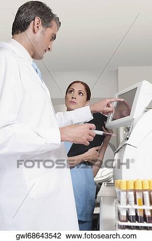 Stock Image - Lab technician testing blood samples in a laboratory. Fotosearch