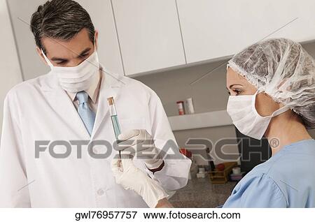 Lab technicians analyzing a sample in a test tube View Large Photo Image Stock Photo - Lab technicians analyzing a sample in a test tube. Fotosearch