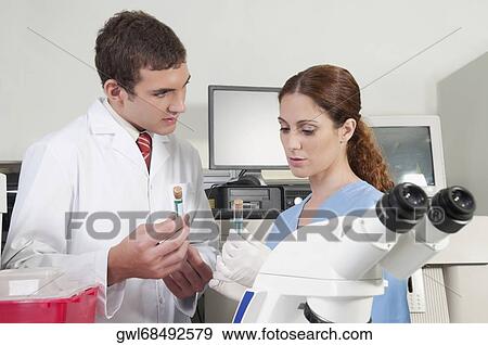 Lab technicians analyzing sample in test tubes View Large Photo Image Stock Photo - Lab technicians analyzing sample in test tubes. Fotosearch