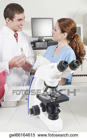 Lab technicians analyzing sample in test tubes View Large Photo Image Stock Photography - Lab technicians analyzing sample in test tubes. Fotosearch