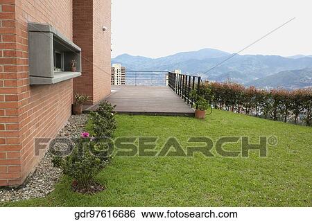 Lawn in the backyard of a house View Large Photo Image Stock Photograph - Lawn in the backyard of a house. Fotosearch