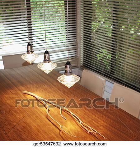 Lights hanging over a dining table View Large Photo Image Stock Image - Lights hanging over a dining table. Fotosearch