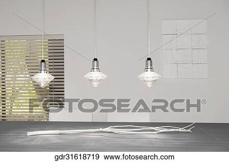 Lights hanging over a dining table View Large Photo Image Stock Photo - Lights hanging over a dining table. Fotosearch