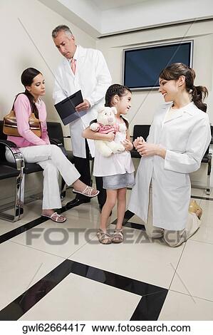 Male and a female doctor with patients View Large Photo Image Stock Photo - Male and a female doctor with patients. Fotosearch