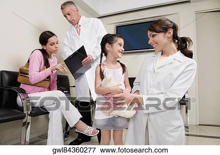 Male and a female doctor with patients View Large Photo Image Stock Photo - Male and a female doctor with patients. Fotosearch