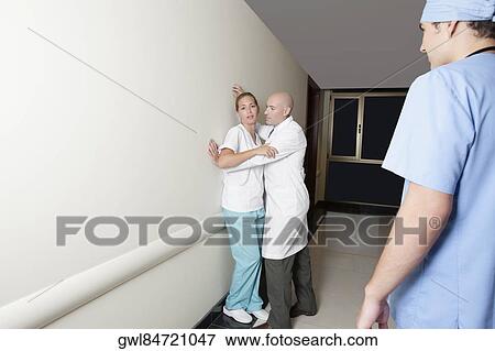 Male doctor flirting with a female nurse in the hospital corridor View Large Photo Image Stock Photo - Male doctor flirting with a female nurse in the hospital corridor. Fotosearch