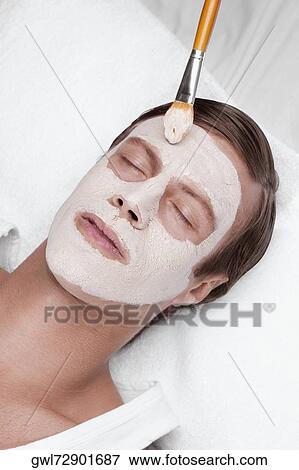 Stock Photo - Man applying face pack. Fotosearch