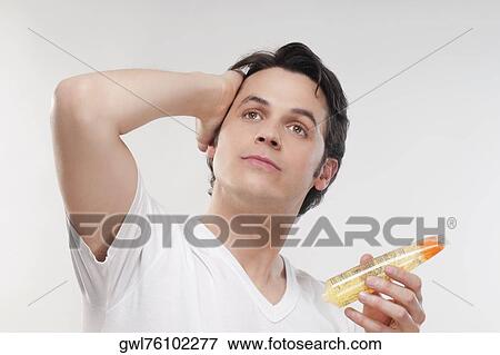 Man applying gel on his hair View Large Photo Image Stock Photo - Man applying gel on his hair. Fotosearch