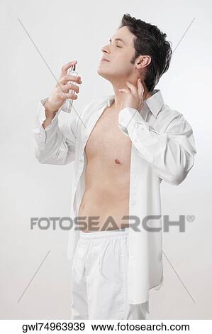 Man applying perfume View Large Photo Image Stock Photo - Man applying perfume. Fotosearch