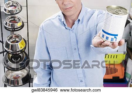 Stock Photograph - Man buying dog food in a supermarket. Fotosearch