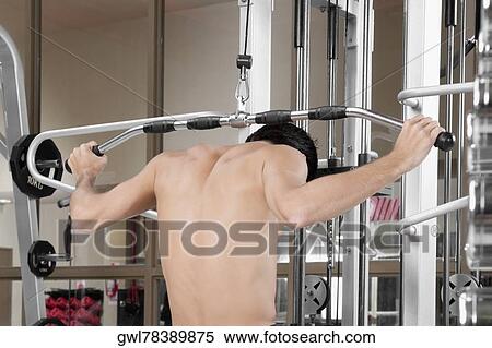 Man exercising in a gym View Large Photo Image Stock Photography - Man exercising in a gym. Fotosearch