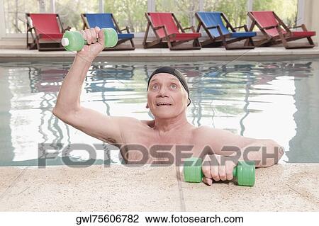 Man exercising with dumbbells in a swimming pool View Large Photo Image Stock Image - Man exercising with dumbbells in a swimming pool. Fotosearch