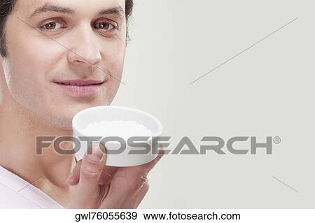 Man holding a container of bath salt View Large Photo Image Stock Photo - Man holding a container of bath salt. Fotosearch