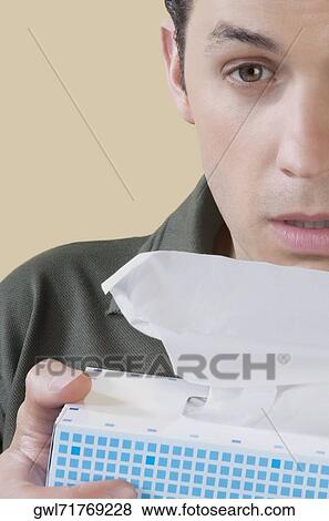 Man holding a tissue paper box View Large Photo Image Stock Photo - Man holding a tissue paper box. Fotosearch