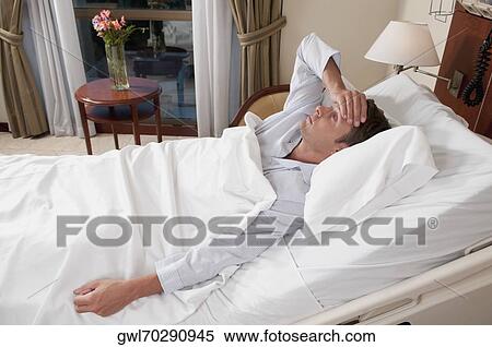 Man lying in a hospital bed View Large Photo Image Stock Photography - Man lying in a hospital bed. Fotosearch