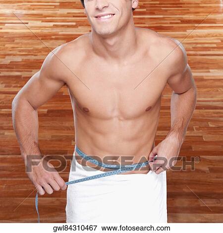 Man measuring his waist with a tape measure View Large Photo Image Stock Photo - Man measuring his waist with a tape measure. Fotosearch