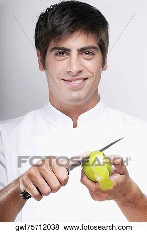 Man peeling a granny smith apple and smiling View Large Photo Image Stock Photo - Man peeling a granny smith apple and smiling. Fotosearch