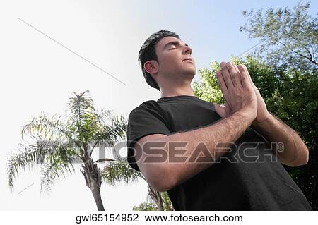 Man practicing yoga in a park View Large Photo Image Stock Image - Man practicing yoga in a park. Fotosearch