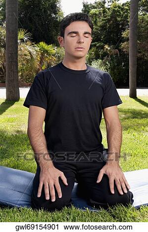 Man practicing yoga in a park View Large Photo Image Stock Image - Man practicing yoga in a park. Fotosearch