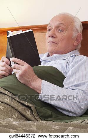 Man reading a book in nursing home View Large Photo Image Stock Image - Man reading a book in nursing home. Fotosearch