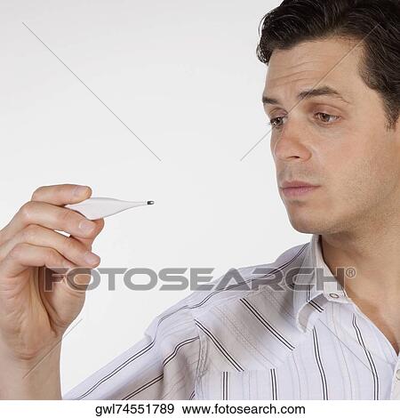 Stock Photo - Man reading a thermometer. Fotosearch