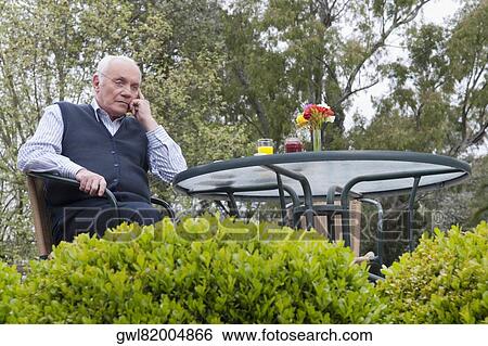 Man sitting in a garden and thinking View Large Photo Image Stock Photograph - Man sitting in a garden and thinking. Fotosearch