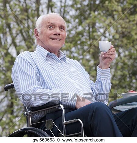 Man sitting in wheelchair and drinking tea View Large Photo Image Stock Image - Man sitting in wheelchair and drinking tea. Fotosearch