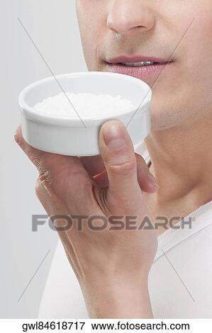 Stock Photo - Man smelling bath salt. Fotosearch