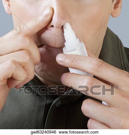 Man using nasal spray View Large Photo Image Stock Photograph - Man using nasal spray. Fotosearch