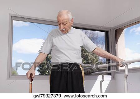 Man walking with a cane View Large Photo Image Stock Photo - Man walking with a cane. Fotosearch