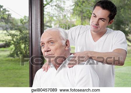 Stock Photo - Massage therapist massaging a man's neck. Fotosearch