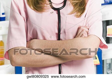 Mid section view of a female pharmacist View Large Photo Image Stock Photography - Mid section view of a female pharmacist. Fotosearch