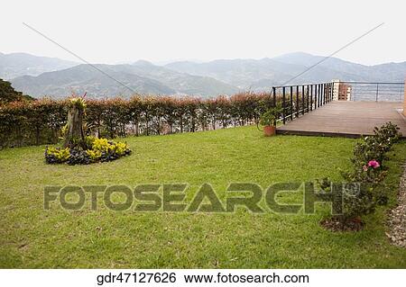 Mountain viewed from the lawn of a house View Large Photo Image Stock Photograph - Mountain viewed from the lawn of a house. Fotosearch