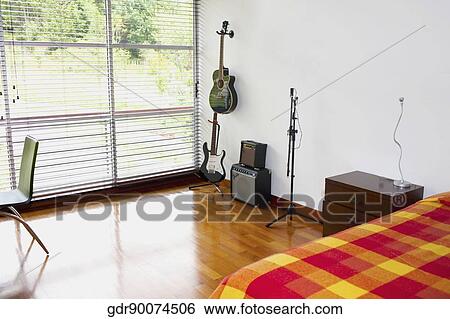 Musical instruments in the bedroom View Large Photo Image Stock Photograph - Musical instruments in the bedroom. Fotosearch