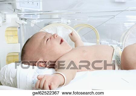 Newborn baby in a hospital View Large Photo Image Stock Photo - Newborn baby in a hospital. Fotosearch