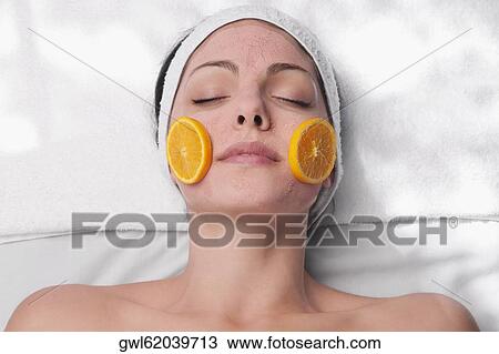 Orange slices on a woman's face View Large Photo Image Stock Image - Orange slices on a woman's face. Fotosearch