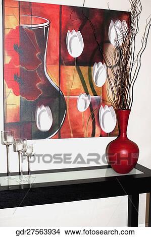 Picture - Paintings on the wall over a table. Fotosearch