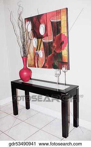 Paintings on the wall over a table View Large Photo Image Stock Image - Paintings on the wall over a table. Fotosearch