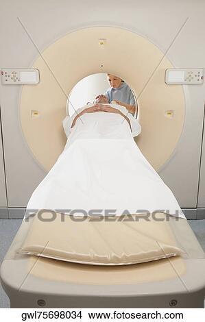 Patient going through an MRI scan View Large Photo Image Picture - Patient going through an MRI scan. Fotosearch