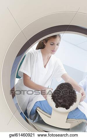 Patient going through an MRI scan View Large Photo Image Stock Image - Patient going through an MRI scan. Fotosearch