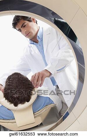 Patient going through an MRI scan View Large Photo Image Stock Image - Patient going through an MRI scan. Fotosearch